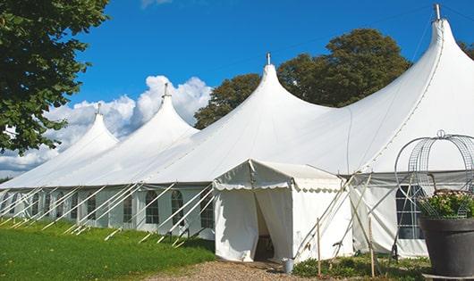 tall green portable restrooms assembled at a music festival, contributing to an organized and sanitary environment for guests in Peckville PA